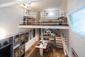 a room with a staircase and a table and chairs at Casa degli Specchi- Duplex in city center in Arona