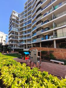 a view of a large apartment building from the garden at LaCalaSuit in Benidorm