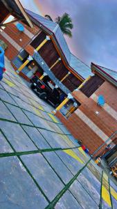 a car parked in front of a house at La Casa Royal Hotel  +2 photos