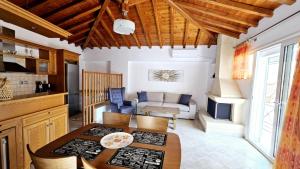 a kitchen and living room with a table and chairs at Like my house in Skiathos