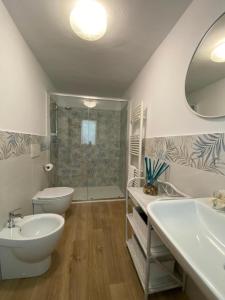 a bathroom with a sink and a toilet and a shower at Casa Marcobando - Lucca in Lucca