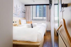 a hotel room with two beds and a window at easyHotel Croydon in Croydon