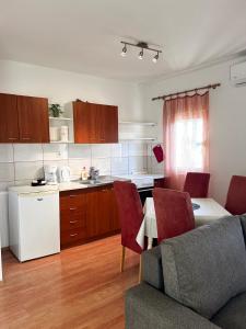 a kitchen with a couch and a table in a room at Family Majčica - villa Malo Misto in Klek