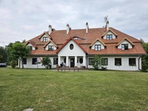 a large white house with a red roof at Apartament ,, Studio '' in Nasutów +10 photos