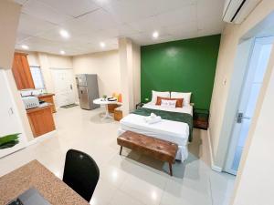 a bedroom with a bed and a green wall at Stacys Place #4 Studio Apartment in Port-of-Spain +10 photos