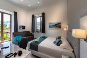 a bedroom with a bed and a couch at Villa Emanuel in Sant'Agnello +57 photos