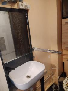 a bathroom with a white sink and a shower at Le havre de faye in Savigny-sous-Faye +2 photos