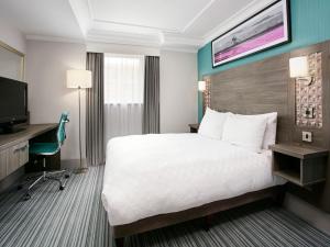 a hotel room with a bed and a tv at Leonardo Hotel Middlesbrough - formerly Jurys Inn in Middlesbrough