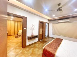 a bedroom with a bed and a projection screen at Nova Grand Canyon in Cochin
