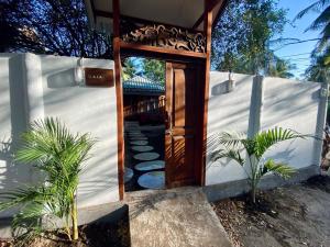 a door to a house with plants in front of it at Gaia cottages in Gili Trawangan +4 photos