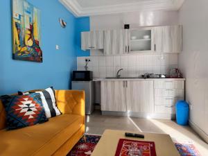 a living room with a couch and a kitchen at Seaview Residence in Fajara