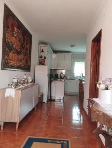 a kitchen with a white refrigerator and a table at Esposende Private Terrace Flat in Outeiro