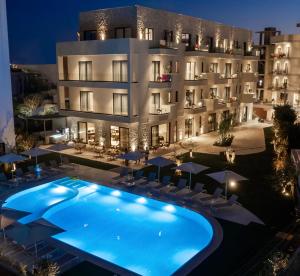 a hotel with a swimming pool in front of a building at Sondor Hotel in Ksamil