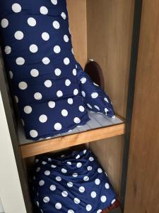 two blue and white polka dot pillows on a shelf at アルピエj107号室無料Wi-Fiあり熊本城徒歩5分 in Kami-kumamoto