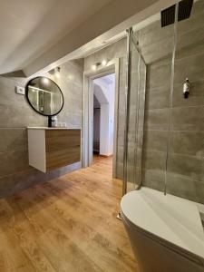 a bathroom with a toilet and a mirror on the wall at Casa Tawny in Pinhão +38 photos