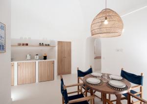 a kitchen and dining room with a wooden table and chairs at Maison Mia Capri in Capri