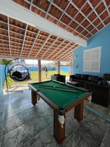 a pool table in the middle of a living room at Casa Encanto da Vila in Saquarema