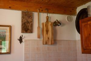apron hanging on the wall of a kitchen at Casa Cantone Devero-baita storica con balcone e giardino, posizione comoda e soleggiata- spazio biciclette in Alpe Devero