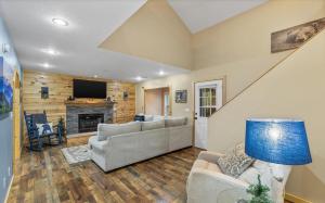 a living room with a couch and a fireplace at Heavenly Sunshine By Stony Brook Cabins in Glade