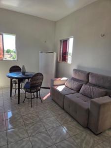 a living room with a couch and a table at Residencial Vicente Mota Neto in Fortaleza