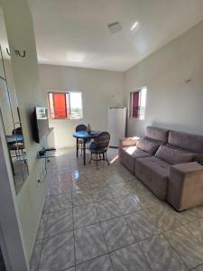 a living room with a couch and a table at Residencial Vicente Mota Neto in Fortaleza