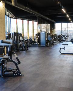 a gym with lots of treadmills and machines at Ap nou cu 2 camere in centrul Bucureștiului in Bucharest