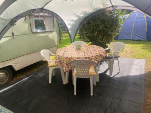 a table and chairs in front of a tent at Major Tom in Commana