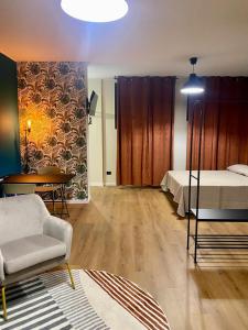 a room with a bed and a table and a couch at menouno in Lecce