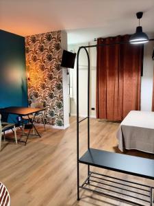 a bedroom with a bed and a table and a dining room at menouno in Lecce +5 photos