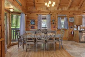 a dining room with a table and chairs in a cabin at Dream View in Greystone Heights