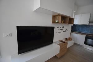 a large flat screen tv on a wall in a kitchen at Casa Lorica in Pieve Ligure