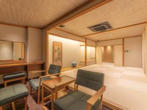a conference room with a table and chairs and a tablektop at Yoshiike Ryokan in Hakone +94 photos