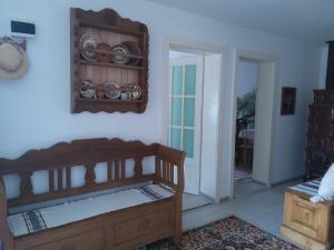 a room with a wooden bed and a mirror at Casa Cătălina in Silvaşu de Jos