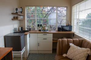 a small kitchen with a counter and a window at Mathys se hys in Springbok