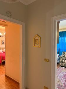 a room with a door leading to a bedroom at Comfyheliopolis in Cairo