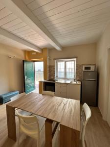 a kitchen with a table and chairs in a room at Il CasaLetto in Valmontone
