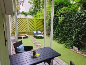 a patio with a table and chairs on a porch at Apartment BERNSTEIN ruhig, familienfreundlich mit Garten, Infrarot-Sauna in Rostock