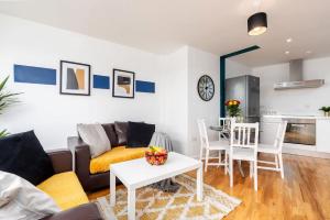 a living room with a couch and a table at Stylish 2BR Apartment near Sheffield City Centre in Sheffield