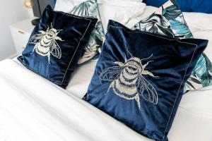two pillows with a drawing of a bug on them at Stylish 2BR Apartment near Sheffield City Centre in Sheffield +23 photos