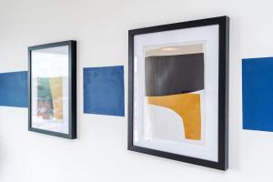 two mirrors on a wall with blue and yellow at Stylish 2BR Apartment near Sheffield City Centre in Sheffield
