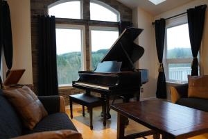 a living room with a piano and a table at Large Estate Venue 2 hot tubs 2 treehouses in Snohomish