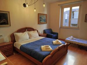 a bedroom with a bed with two towels on it at Botticelli Sea Apartment in Trieste +21 photos