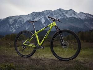a bike parked on a field with mountains in the background at Apartman Žile in Bačka Palanka