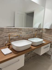 a bathroom with a white sink and a mirror at La Foresteria in Galşa +11 photos