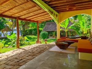 an outdoor patio with a couch and a table at Villa Naicha in Sainte Marie +28 photos