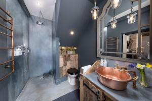 a bathroom with a copper sink and a mirror at Cheshire Boutique Bathhouse in Nantwich +57 photos