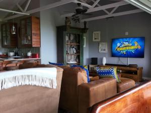 a living room with couches and a flat screen tv at Santa Vista 1 in Santa Maria