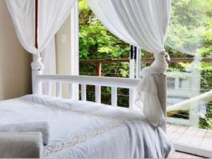 a bedroom with a white bed and a large window at Santa Vista 1 in Santa Maria +56 photos