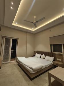 a bedroom with a bed with a ceiling fan at HOTEL HERITAGE Inn in Indore