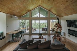 a living room with a couch and a table at Unic lofts - Ligali - Massif Charlevoix, Mont-St-Anne in Saint-Joachim